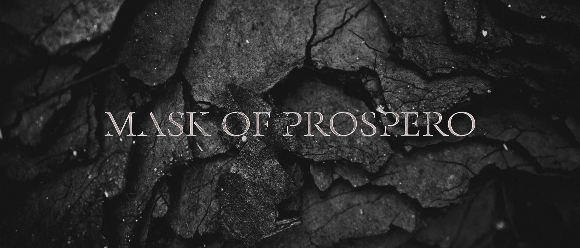 Mask of Prospero title mark in fine serif type set over a cracked, kintsugi-textured dark surface
