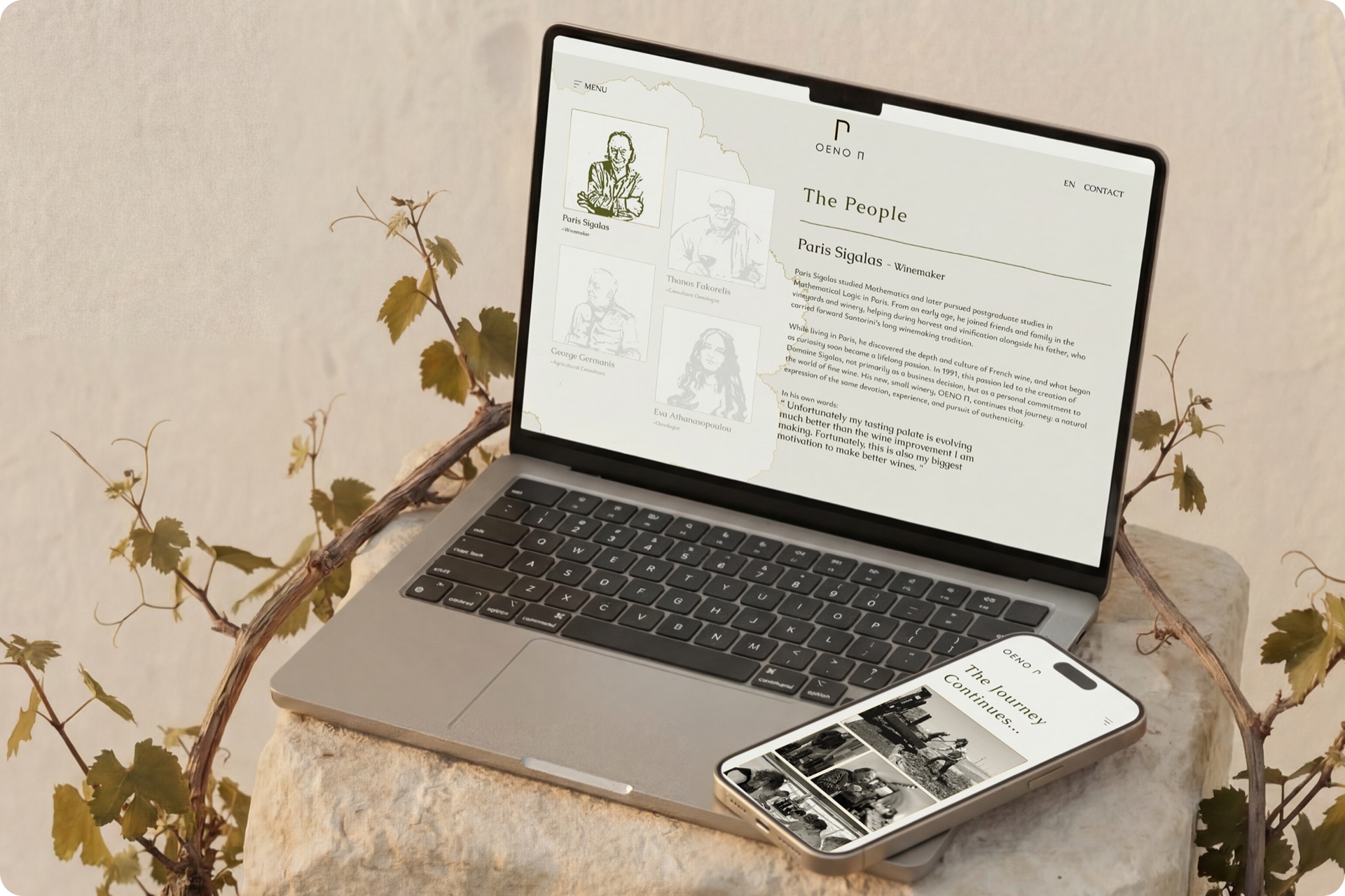MacBook on a stone pedestal showing 'The People' page with hand-illustrated portraits of Paris Sigalas and the OENO P team, an iPhone leaning beside it