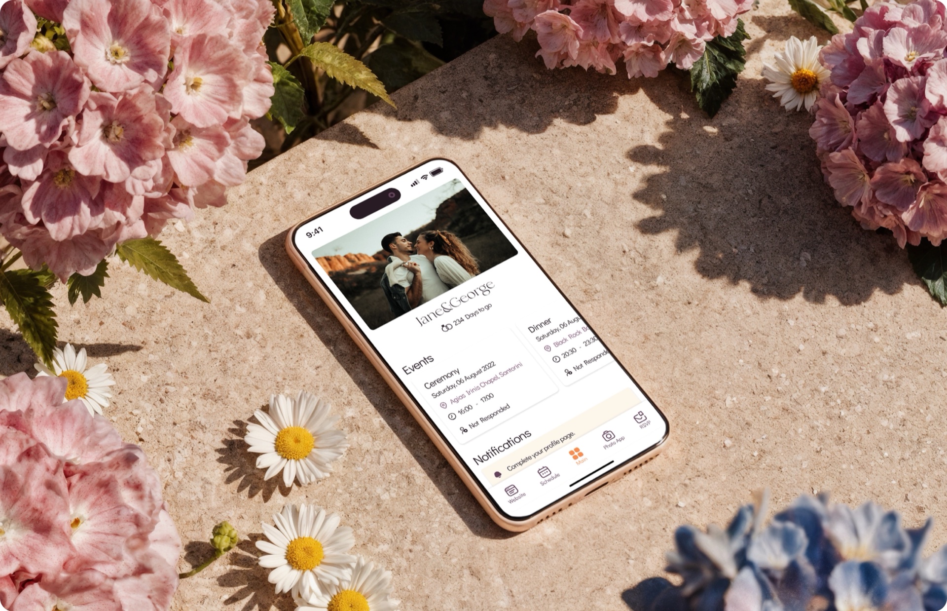 iPhone laid on hydrangeas and daisies, showing the WhiteClover invitation and RSVP screen for Jane & George