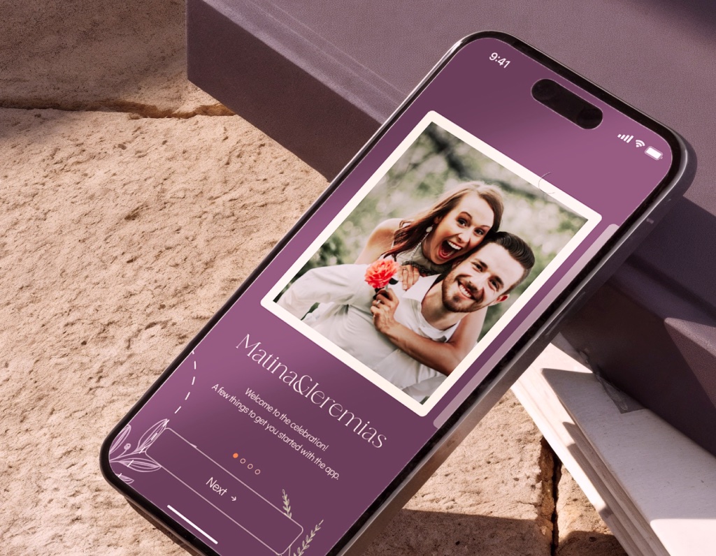 Couple's WhiteClover wedding website previewed on an iPhone in a soft floral setting